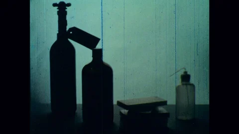 1960s: Tank of methane, bottle of octane, stack of bars of paraffin and a Video stock 127732815