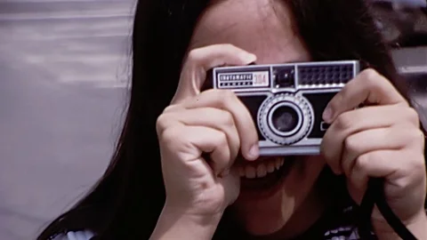 1960s Teen Girl HOLDS Instamatic CAMERA Takes Picture Vintage Film Home Movie Stock Footage 81227978