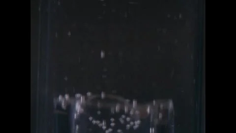 1960s: Test tube.  Bubbles float up. Stock Footage 248548690