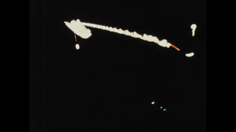 1960s: Tethered Agene hangs below Gemini craft. Astronaut in space suit performs Stock Footage 101665552
