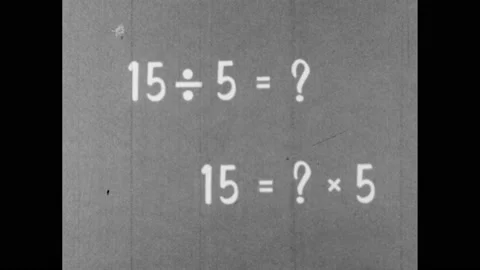 1960s: Text explains how to use multiplication and division. Boy looks pensive Stock Footage 156431488