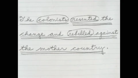 1960s: Text on notebook paper. Hand holding pencil, underlining words on paper Stock Footage 188530597