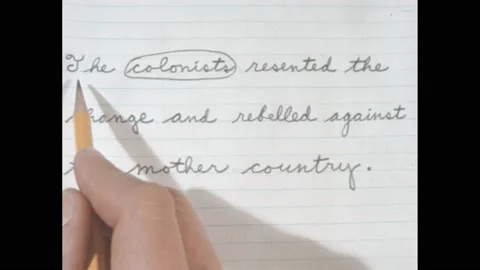 1960s: Text on notebook paper. Hand holding pencil, circling, underlining words Stock Footage 188530603
