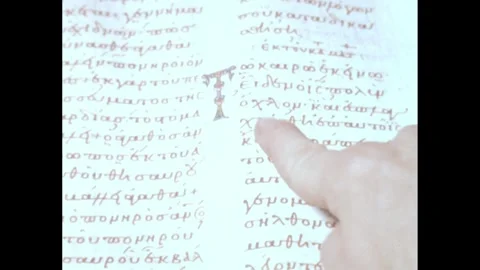 1960s: Text on page of scripture. Person runs finger along lines of text. Stock Footage 247067283