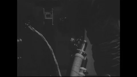 1960s: Tilt up and down man modeling space suit. Stock Footage