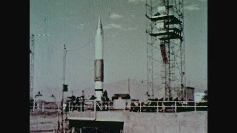 1960s: Tower is pulled back from rocket on launch pad. Rocket launches into sky. 스톡 동영상 124817314