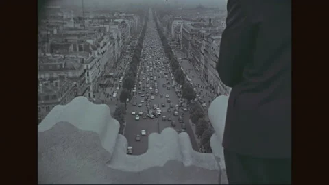 1960s: Traffic flows through the bustling streets of Paris, converging at the Stock Footage 156939721