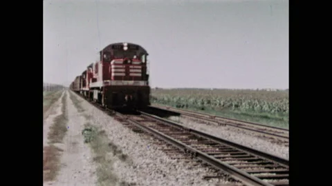 1960s: Train moves down train tracks. Vehicles on highway. Map of Central Video stock 149642412