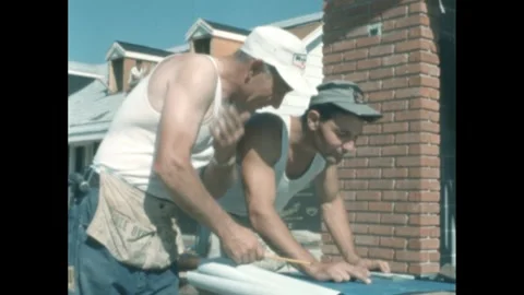 1960s: Two men on construction site look at blueprints. Stock Footage 275727631