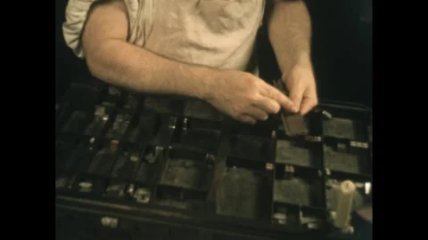 1960s: Typesetter sets type in trays. Stockbeeldmateriaal 277614262
