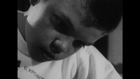1960s: UNITED STATES: boy does arithmetic. Boy counts on fingers. Boy adds Stock Footage 102796751