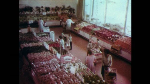 1960s: UNITED STATES: ladies buy fruit and vegetables in grocery store. Lady Stock Footage 91451675