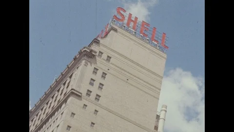 1960s: UNITED STATES: Shell logo on roof of building. Sky and trees by building. Stock Footage 104883361