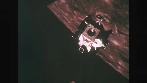 1960s: UNITED STATES: space capsule above surface of moon Stock Footage