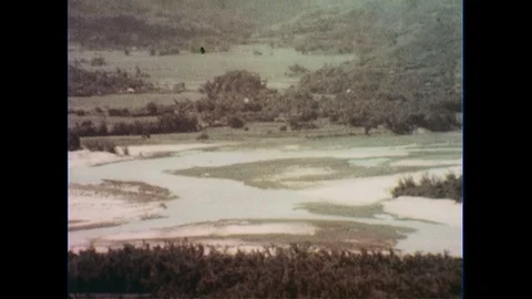 1960s: View of field, zoom out to officers talking to soldiers. Stock Footage