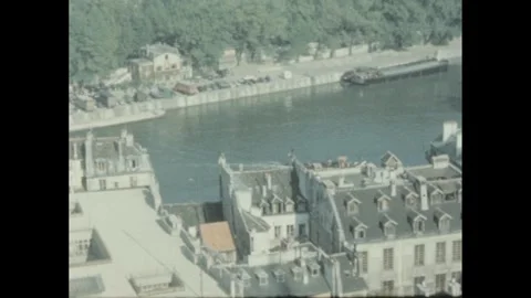 1960s: view of Paris rooftops and the Seine River from above, including the Stock Footage 289157916