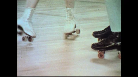 1960s: View of roller skates / Boy and girl skate / View of skates / Teens skate Stock Footage 74666365