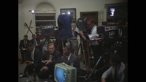 1960s Washington DC: Interior White House. Cameramen ande media cover the Stock Footage 153547787