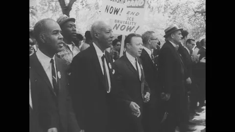 1960s Washington DC: People walk down street in peaceful protest. Stock Footage