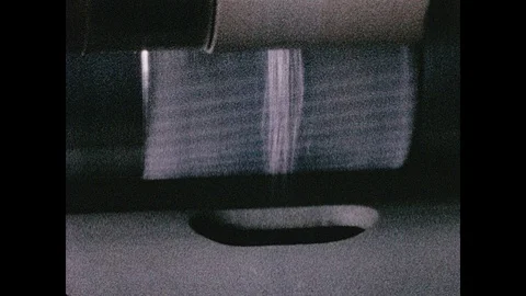 1960s: White threads move though machine, spin onto cone. Stock Footage 104730611