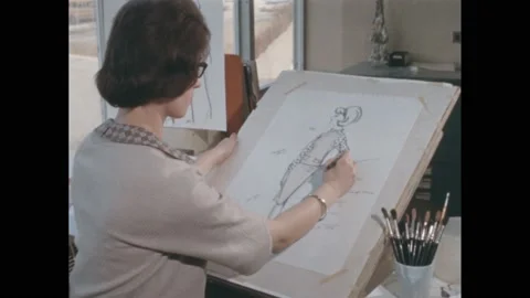 1960s: Woman sketches female fashion model, outfit, writes notes in margin. Cup Stock Footage