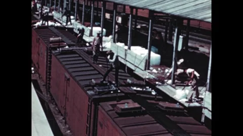 1960s: Workers on dock by ship. Workers loading ice into train cars. Map of Video stock 264968345