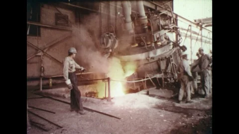 1960s: Workers in steel mill / Molten metal in furnace / Worker by furnace, Stock Footage