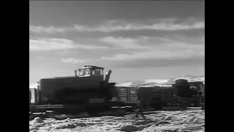 1961 - Camp Century construction workers board wannigans, and sleds pull Stock Footage 85950110