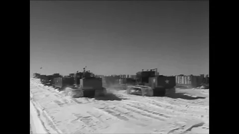 1961 -A convoy of sleds pulls supplies towards Camp Century, and men cook, eat, Stock Footage 85950479