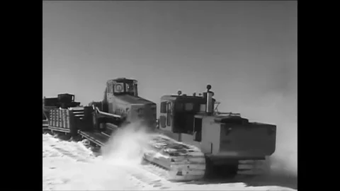 1961 -A convoy of sleds pulls supplies, and a helicopter and Polecats arrive at Stock Footage 85950483