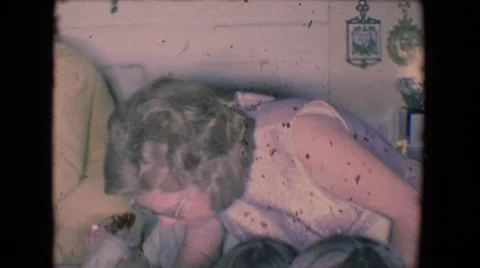 1961: party of children gathered around a dining table, enjoying plates Stock Footage