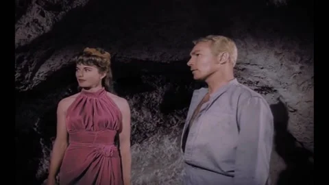 1961 - In this Sci-Fi action adventure film, a man and woman look at a trapped Stock Footage 218365996