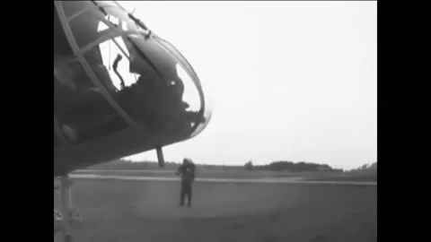 1961 - Test engineer demonstrates flight in a rocket belt to a crowd in Stock Footage 232894149