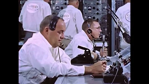 1962- Aerospace engineers sit at control panels preparing for the launch of Stock Footage 86823586