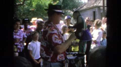 1962: in crowded monkey show, showman collects something Stock Footage