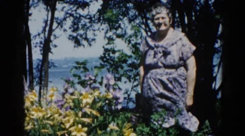 1962: grandma enjoys a beautiful spring day with a breeze near the shore. Stock Footage