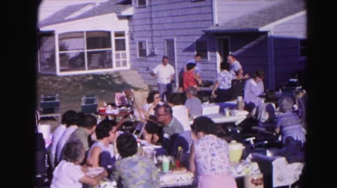 1962: a large number of people gather on a clear sunny day on benches Stock Footage