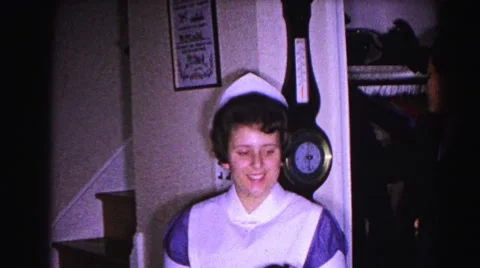 1962: nurse playfully helps boy put away his hat HAGERSTOWN, MARYLAND Stock Footage