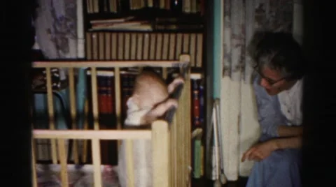 1962: old woman in room talking to baby standing in crib HAGERSTOWN, MARYLAND Stock Footage