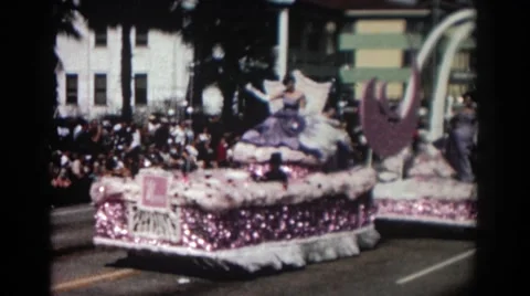 1962: a parade float driving in a parade with beautiful brunette woman  Stock Footage 68801318