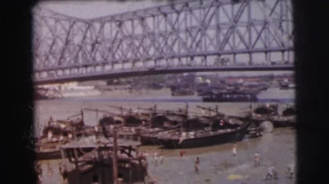 1962: people in water with old war boats CALCUTTA Stock Footage
