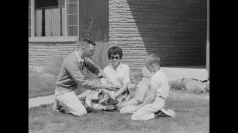 1962 - USAF Captain Ted Twinting is seen on his front lawn with his wife and Stock Footage 123876648