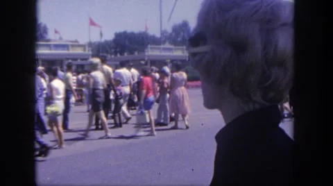 1962: various people entering and exiting a large amusement park DISNEYLAND Stock Footage