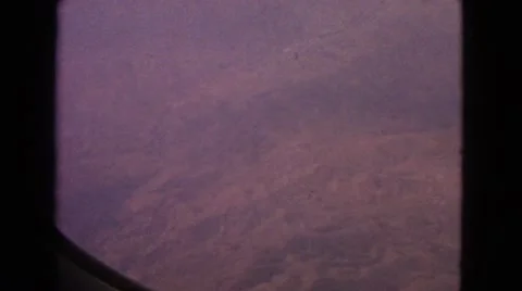 1963: Airplane Window View of Patchwork Countryside and Mountain Ranges Video stock 67471679