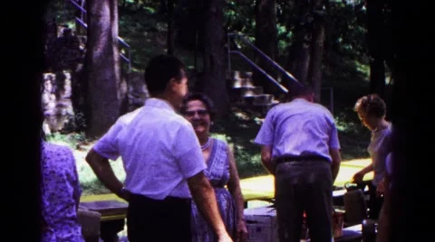 1963: attendees at an outdoor gathering hug and shake hands COLD SPRINGS Stock Footage