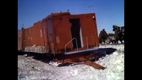 1963 - Camp Century construction workers board wannigans, and sleds pull Stock Footage 84722963