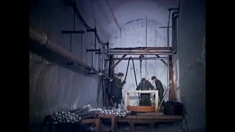 1963 Construction workers create a well and install an electrical heating system 動画素材 115374834