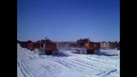 1963 -A convoy of sleds pulls supplies towards Camp Century, and men cook, eat, Stock Footage 84722970