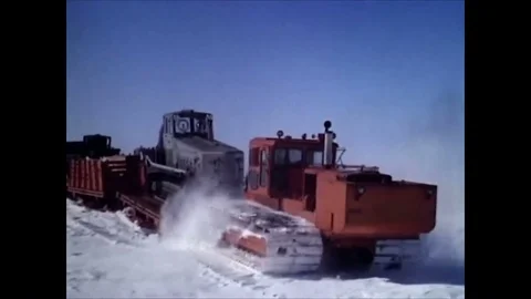 1963 -A convoy of sleds pulls supplies, and a helicopter and Polecats arrive at Stock Footage 84722973