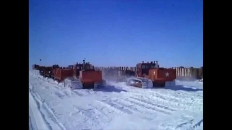 1963 A convoy of sleds pulls supplies towards Camp Century, and men cook, eat, Stock Footage 115375028